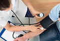 Provider checking a patient's blood pressure during a wellness visit