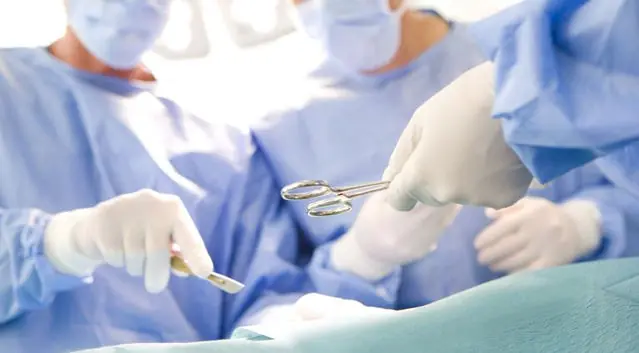 Provider completing preoperative clearance documentation with a patient